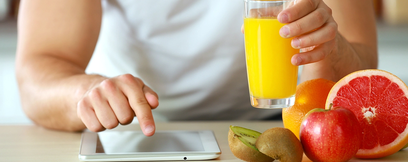 Hoeveel Calorieën (kcal) Moet je Verbranden om 1 Kilo Vet Af te Vallen? Man counting calories on tablet