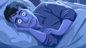 Man ligt in bed en kan niet slapen